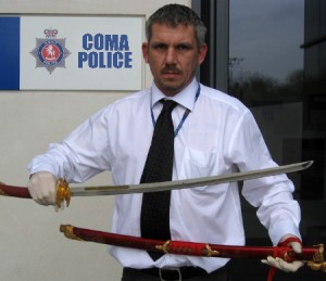 A Coma police officer displays a deadly Katana Samurai sword before the cake-cutting ceremony